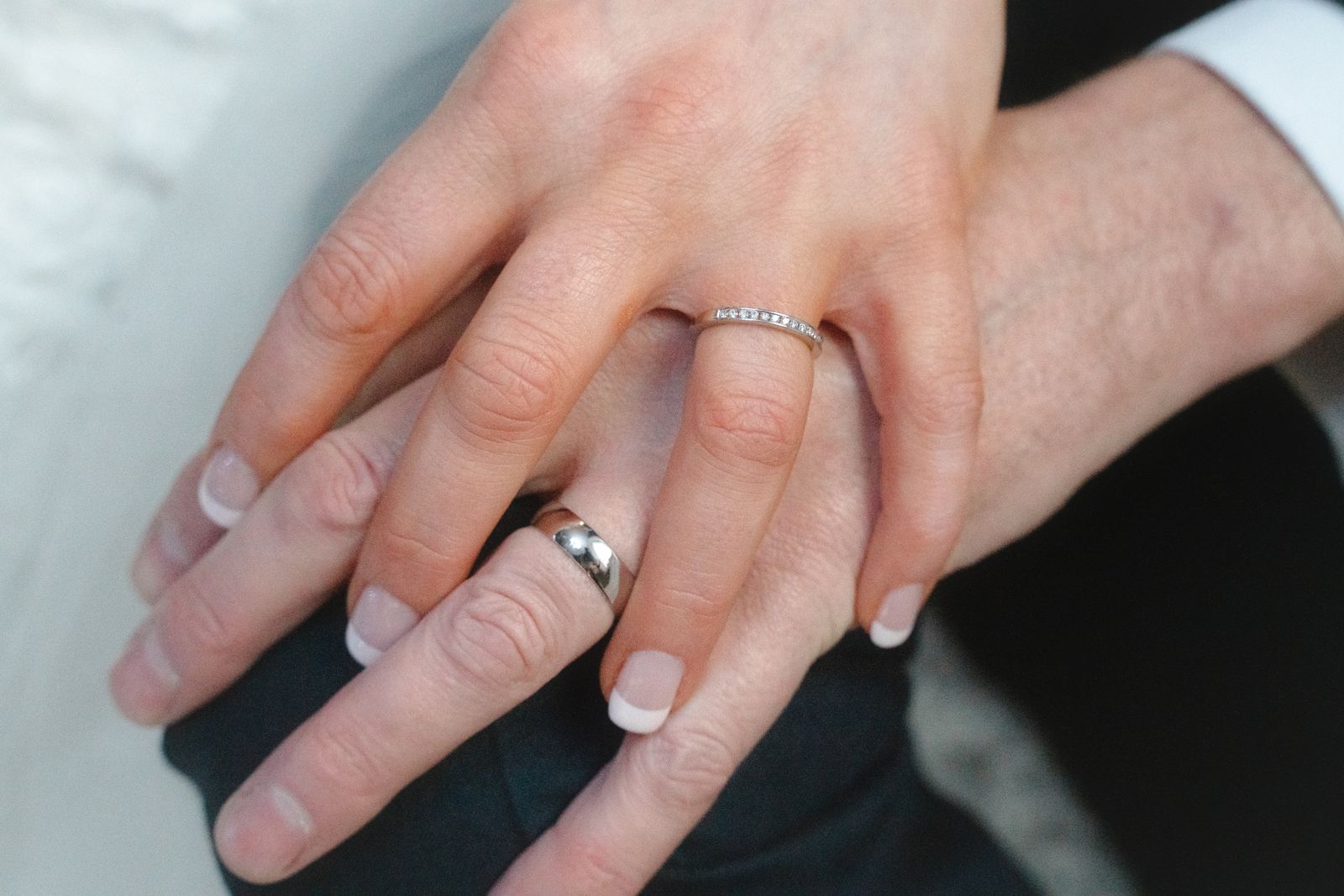 wedding rings on an engaged couple's hands, the point where a Michigan prenup becomes binding